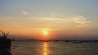 Salah satu lokasi favorit untuk melihat senja adalah di Surabaya North Quay (SNQ). Spot indahnya ada di lantai tiga pelabuhan tanjung perak. (Doohan Aditya Saputro/dTraveler)