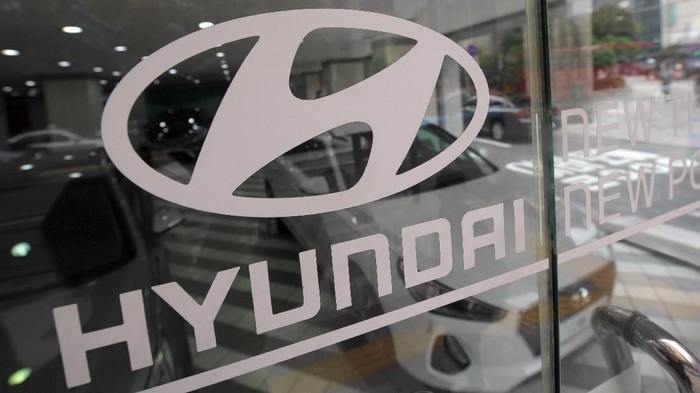 The logo of Hyundai Motor is seen on a glass door at a dealership in Seoul on October 26, 2016.
South Koreas Hyundai Motor on October 26 announced a sharp fall in profits for a third quarter, hit by lengthy industrial action that also took a toll on the national economy.  / AFP PHOTO / JUNG YEON-JE