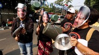 Alat rumah tangga seperti panci dan ember itu mereka mereka pamerkan di tengah orasi. Mobil pengangkut barang juga diparkir di lokasi demo.