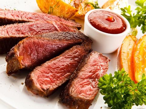 Grilled beefsteak with baked potatoes on white background