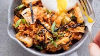 Korea juga punya nasi goreng, namanya Kimchi Fried Rice. Sesuai dengan namanya, nasi goreng itu dipadu dengan kimchi. Sehingga warnanya merah dan rasanya sedikit pedas. Saat ini, kimchi fried rice umum disajikan dengan telur ceplok dan parutan keju. Foto: Instagramthrivemkt