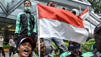 Mereka mengibarkan bendera Merah Putih.