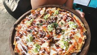 Berlibur ke Bali, Ezra pesan nachos dengan topping daging dan saus pedas untuk menikmati liburannnya bersantai di pantai. Ssst! Ezra gak mau bagi-bagi lho! Foto: Instagram @ezrajwilliam