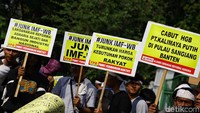 Di bawah terik matahari, massa membawa serta poster dan spanduk berisikan tuntutan mereka kepada pemerintah.