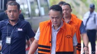 Fahmi berjalan menuju gedung KPK sambil menunduk.