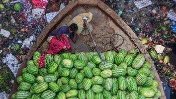 Floating Life on River Under Pollution oleh fotografer Tapan Karmaker ikut dalam deretan foto terbarik. Memperlihatkan pedagang semangka istirahat di kapalnya di tengah sungai Burigongga di Bangladesh yang penuh polusi. Foto: Environmental Photographer Of The Year