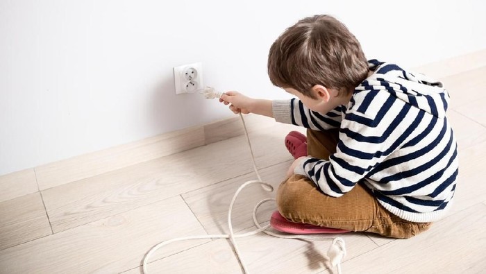 Father takes care of the safety of the child. Electrical security for safety home of ac power outlet for babies, baby hands playing with electric plug
