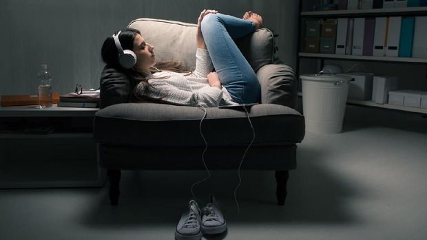 930243994 Cute Smiling Female Listening to Music with Headphones in Car