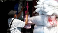 Salah seorang pedagang tampak sedang merapikan beberapa barang yang akan dijual.