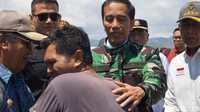 Jokowi mengenakan jaket loreng hijau-hitam TNI.