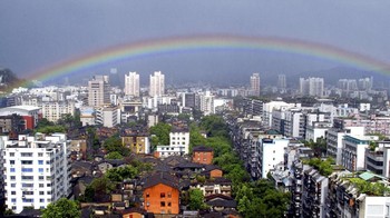 Munculnya pelangi di atas gedung-gedung perkotaan setelah terjadinya badai hujan dan angin topan pada 19 Juli 2005 di Fuzhou, Provinsi Fujian, Cina. (Foto: Getty Images)