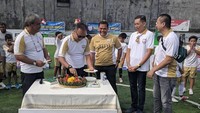 Di sini Menteri Agus terlihat serius memotong nasi tumpeng. Momen ini diabadikan saat meresmikan sekolah sepak bola ASIANA Soccer School. Foto: instagram @agusgumiwangk