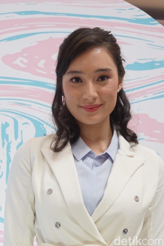 Tatjana membuat gaya maskulinnya tetap terlihat cantik dengan tatanan rambut bergelombang dan sapuan makeup natural berlipstik pink. Foto: Alissa Safera/Wolipop