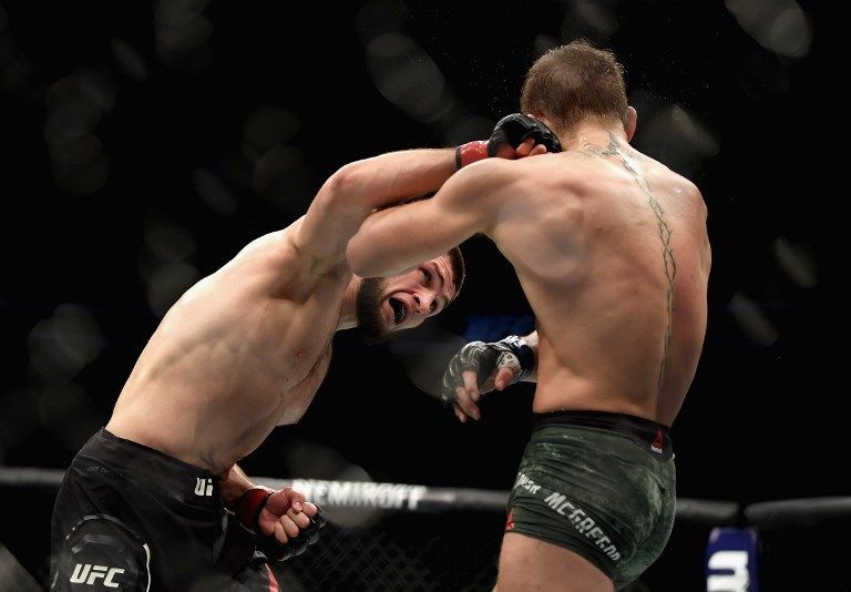 LAS VEGAS, NV - OCTOBER 06: Khabib Nurmagomedov of Russia (L) punches Conor McGregor of Ireland in their UFC lightweight championship bout during the UFC 229 event inside T-Mobile Arena on October 6, 2018 in Las Vegas, Nevada.   Harry How/Getty Images/AFP