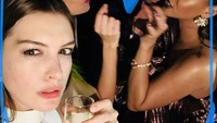 Aktris cantik berusia 35 tahun ini, akrab dengan Rihanna. Ia terlihat asyik meminum champagne dengan Rihanna di belakangnya. Foto: Instagram @annehathaway