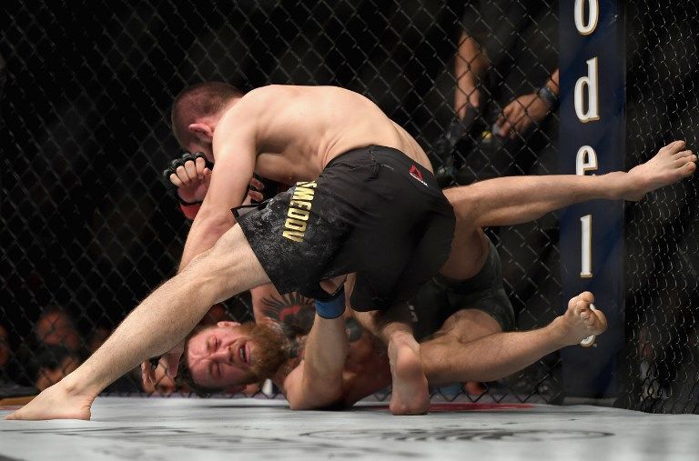 LAS VEGAS, NV - OCTOBER 06: Khabib Nurmagomedov of Russia (top) punches Conor McGregor of Ireland in their UFC lightweight championship bout during the UFC 229 event inside T-Mobile Arena on October 6, 2018 in Las Vegas, Nevada. Harry How/Getty Images/AFP