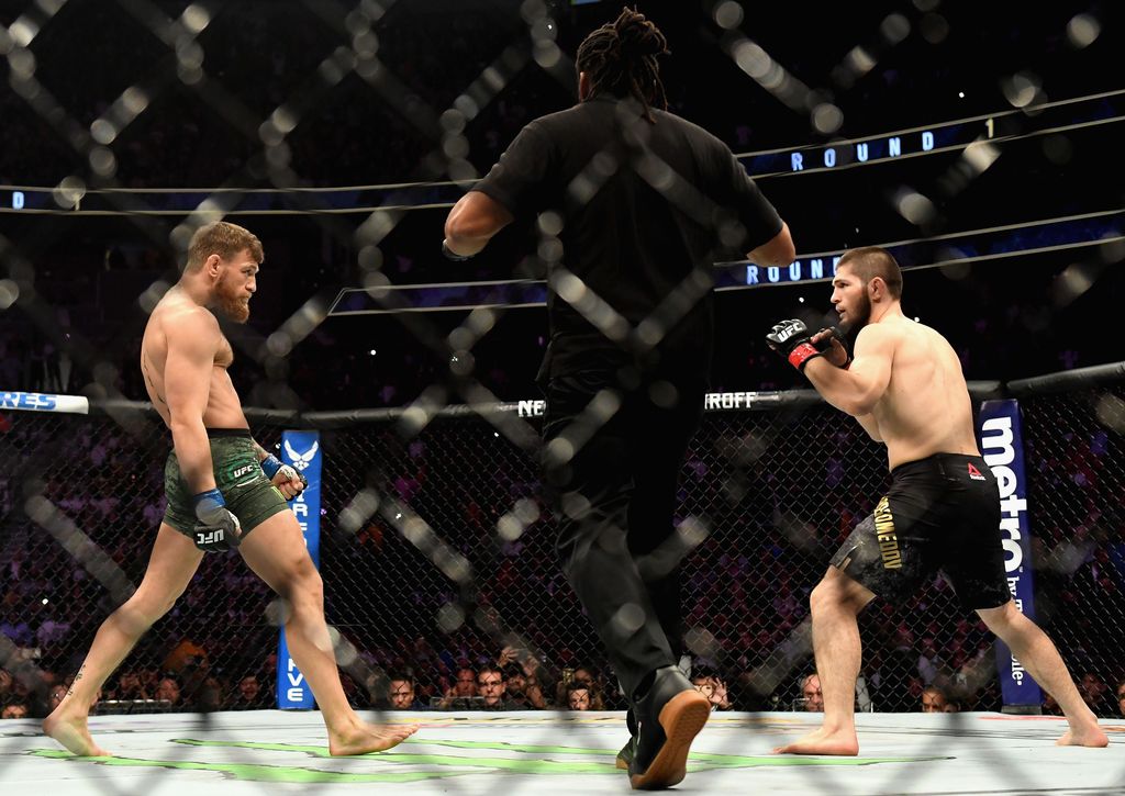 LAS VEGAS, NV - OCTOBER 06:  Khabib Nurmagomedov of Russia (R) and Conor McGregor of Ireland (L) start their UFC lightweight championship bout during the UFC 229 event inside T-Mobile Arena on October 6, 2018 in Las Vegas, Nevada.  (Photo by Harry How/Getty Images)