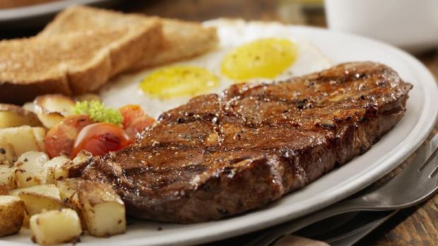 Grilled Rib Eye Steak with Sunny-side up Eggs, Hash Browns, Grilled Tomatoes and Toast -Photographed on Hasselblad H3D2-39mb Camera