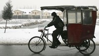 Masih di China, tak hanyamemiliki pilihan becak dengan tempat duduk penumpang yang terbuka. Di sejumlah daerah di China ada pula becak dengan tempat duduk penumpang yang tertutup layaknya sebuah kabin kecil. Becak ini menjadi pilihan yang pas untuk para penumpang yang ingin berkativitas di musim dingin. Andrew Wong/Getty Images
