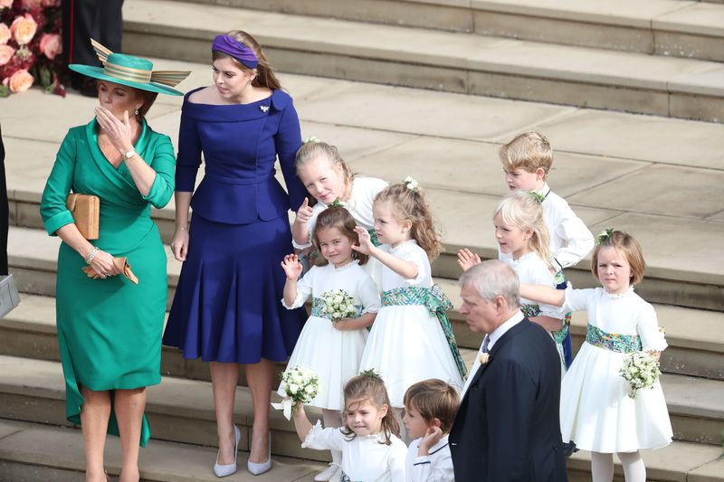WINDSOR, ENGLAND - OCTOBER 12: Sarah, Duchess of York and Princess Beatrice of York and the bridesmaids and page boys, including Princess Charlotte and Prince George, wave off Princess Eugenie of York and Mr. Jack Brooksbank following their wedding at St. George's Chapel on October 12, 2018 in Windsor, England. (Photo by Andrew Matthews - WPA Pool/Getty Images)