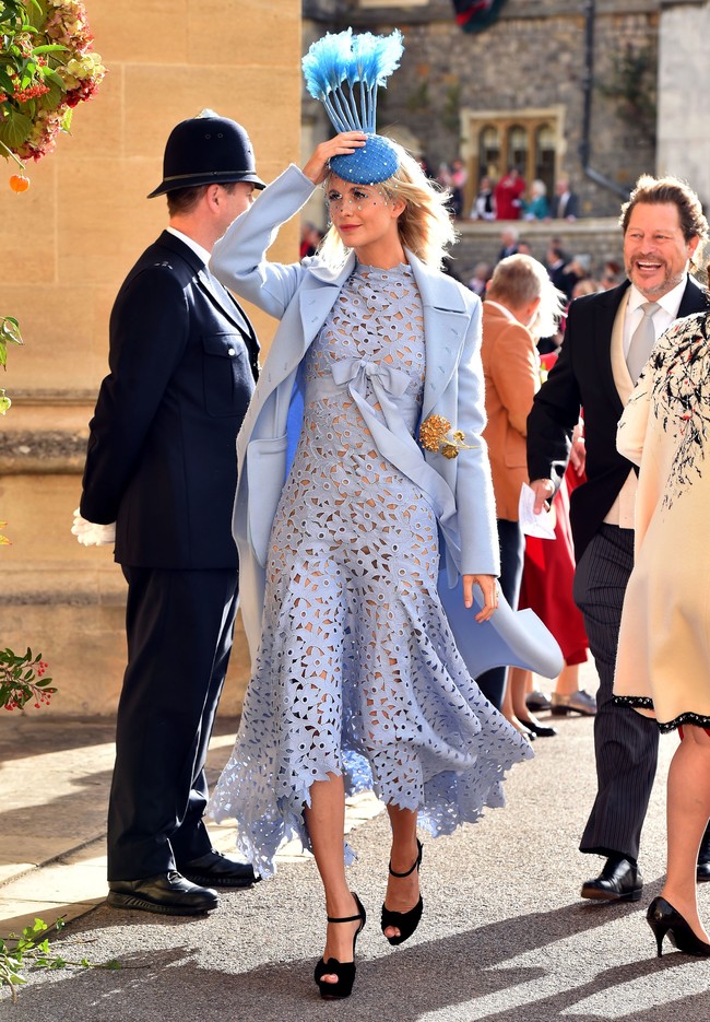 Kakak Cara Delevingne yang juga seorang model, Poppy Delevingne tampil cantik dengan gaun brokat biru. Gaunnya dipadukan bersama pilihan topi yang unik dengan bulu tinggi di ujungnya. Foto: Dok. Getty Images