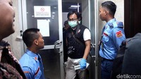 Personel tim Labfor membawa beberapa tas dan koper berukuran sedang berwarna hitam.