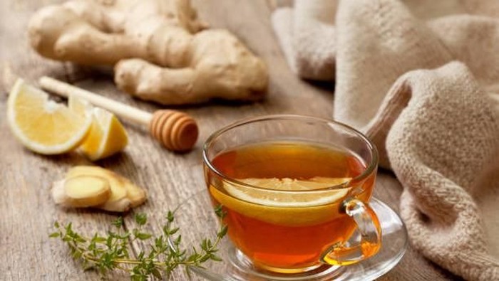 tea with ginger, lemon and thyme on old wooden background