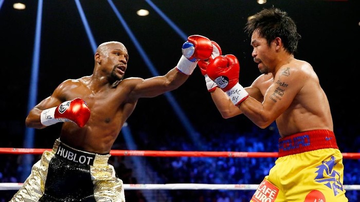 LAS VEGAS, NV - MAY 02:  Floyd Mayweather Jr. throws a left at Manny Pacquiao during their welterweight unification championship bout on May 2, 2015 at MGM Grand Garden Arena in Las Vegas, Nevada.  (Photo by Al Bello/Getty Images)