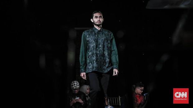 Model memeragakan busana rancangan Oscar Lawalata di Plaza Mandiri, Jakarta.