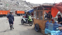 Kondisi di TPST Bantargebang, Minggu (21/10/2018) siang, sejumlah pekerja dan pedagang beraktivitas di dekat bukit-bukit sampah. (Isal Mawardi/detikcom)
