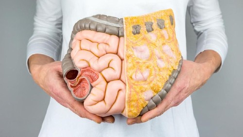 woman with colorectal cancer concept on the pink backgorund