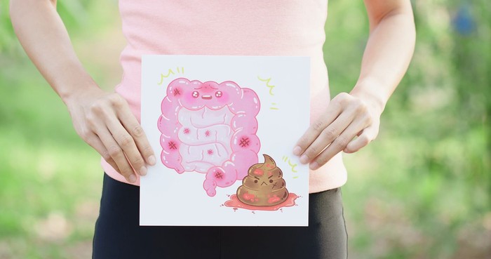 woman with colorectal cancer concept on the pink backgorund