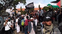 Aksi turun ke jalan ini buntut dari pembakaran bendera berkalimat tauhid. Massa mengibarkan bendera putih dan hitam bertuliskan kalimat tauhid.