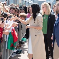 Meski berstatus pengawal bersenjata, sang bodyguard tetap bersolek dalam balutan busana feminin. Saat mengawal Meghan di Sydney, perempuan berambut pirang itu tampil smart chic dengan blus hijau yang dibungkus blazer hitam serta sepatu flat bermotif kulit ular. (Foto: Getty Images)