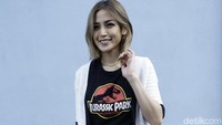 Jessica Iskandar kali ini memadukan kaus hitam Jurassic Park dengan rok aksen kuning dan sandal jepit. Foto: dok Palevi/detikHOT