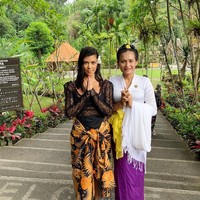 Selama liburan di Bali, Kourtney Kardashian terlihat menerapkan gaya busana yang menarik. Dalam salah satu fotonya, ibu tiga anak tersebut terlihat memakai kain sebagai sarung. Kain tradisional Indonesia itu tampak kontras dengan busana berenda transparan yang digunakannya. Foto: Instagram @kourtneykardash