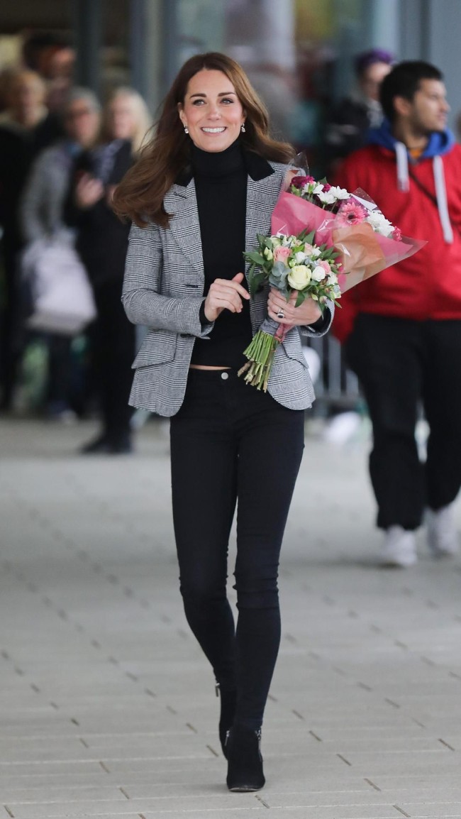 Turut menyempurnakan gayanya, sepasang ankle boots hitam bergaya edgy yang dipermanis dengan aksen retsleting. (Foto: Getty Images)