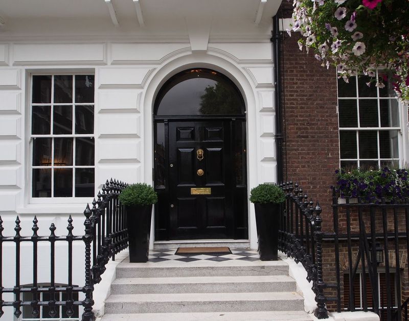 metaphorical welcome image showing a classical door with welcome sign and a red rose - rendering