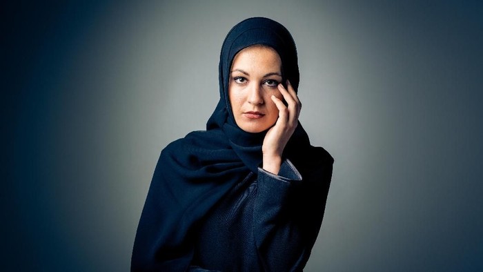 studio shot of young woman wearing traditional arabic clothing