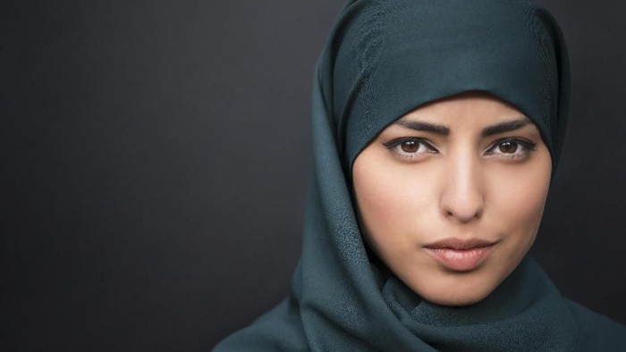 studio shot of young woman wearing traditional arabic clothing