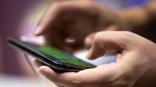 CHIBA, JAPAN - SEPTEMBER 20:  A booth attendant plays a video game on a smartphone during the Tokyo Game Show 2018 on September 20, 2018 in Chiba, Japan. The Tokyo Game Show is held from September 20 to 23, 2018.  (Photo by Tomohiro Ohsumi/Getty Images)