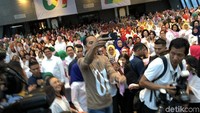 Baju yang dikenakan Jokowi berlengan panjang dan berwarna cokelat. Di bagian depan kaus, terdapat tulisan #01.