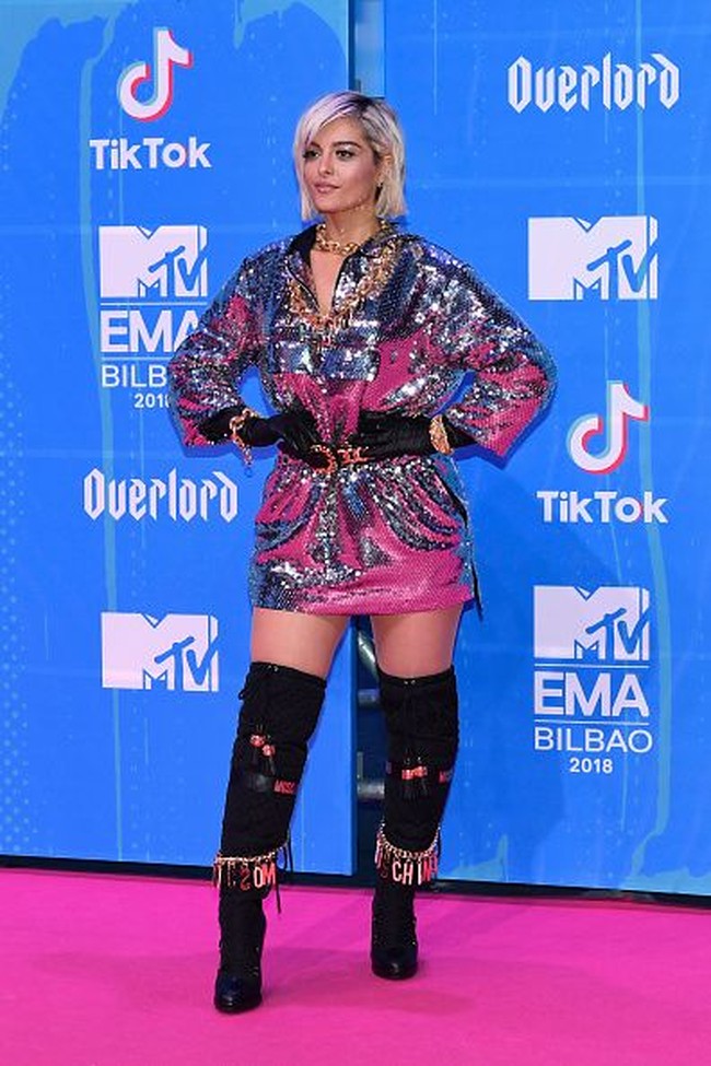 Penyanyi dan penulis lagu Bebe Rexha tampil mencuri perhatian dengan dress ber-hoodie warna silver. Gayanya semakin nyentrik dengan belt, sarung tangan, dan kalung rantai. Foto: Getty Images