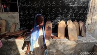 Mereka mencoba menulis Alquran menggunakan papan kayu. REUTERS/Zohra Bensemra.