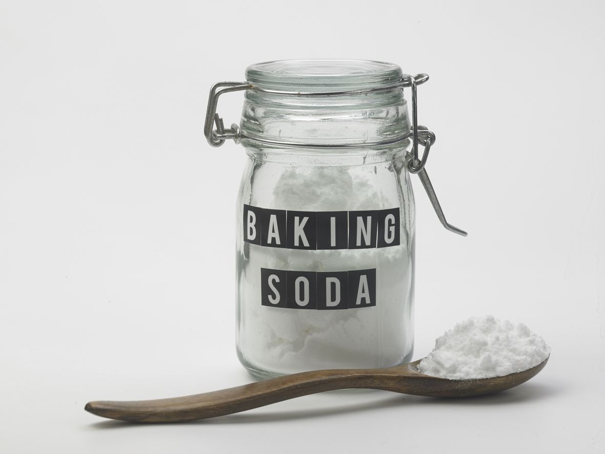jar of baking soda and spoon on the white background