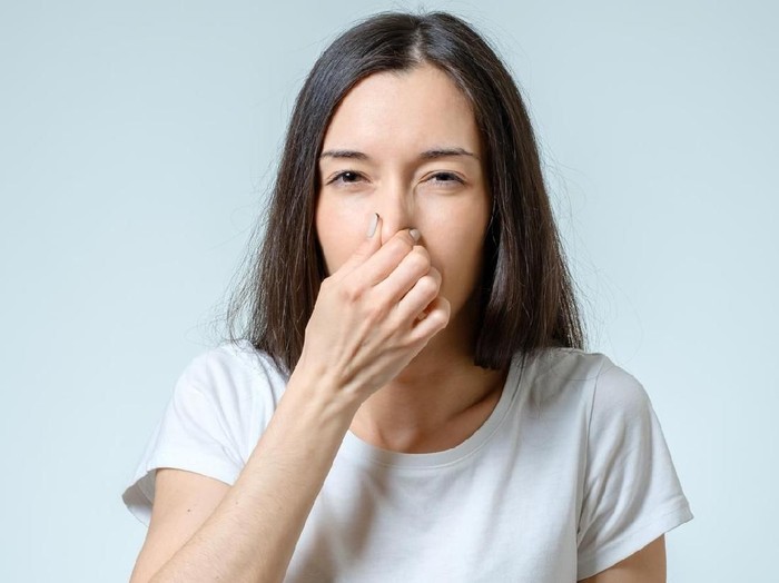 Young Woman Noticed Smell Coming From Dishwasher In Kitchen
