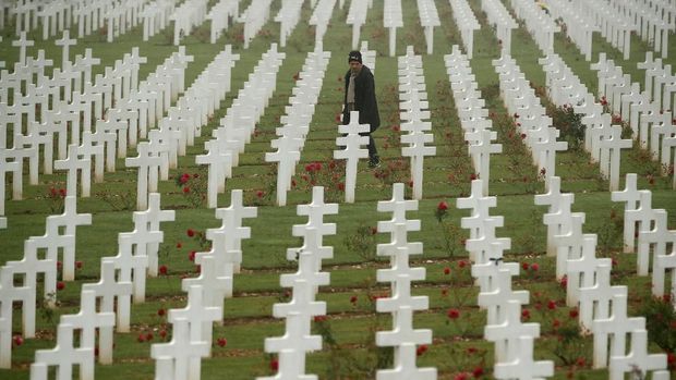 A man walks among the tombstones at the cemetery outside the WWI Douaumont Ossuary, as France prepares to mark the centenial commemoration of the First World War Armistice Day, near Verdun, France,  November 5, 2018. Picture taken November 5, 2018. REUTERS/Christian Hartmann