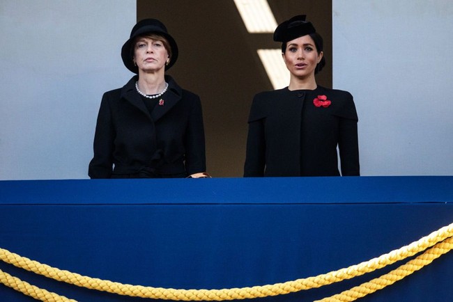 Meghan tampil dalam balutan coat berkancing dengan potongan lengan seperti cape berwarna hitam saat menghadiri  Remembrance Day Service. Penampilannya dilengkapi dengan topi khas para keluarga bangsawan Inggris. Foto: Jack Taylor/Getty Images