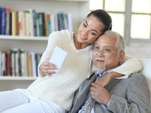 ayah dan anak Family taking selfie at home, enjoying time together.