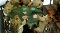Ada kodok yang sedang makan layaknya manusia, bermain kartu sampai bilyard. Mereka dibuat semirip mungkin dengan kehidupan manusia abad ke-19. (REUTERS/Denis Balibouse)